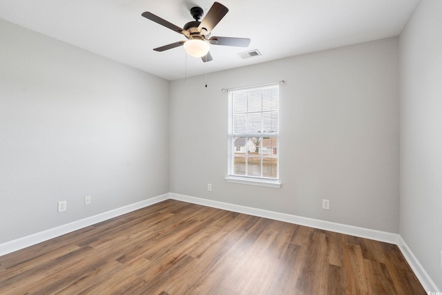 empty room with ceiling fan and hardwood / wood-style floors