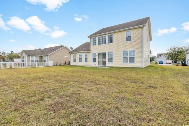 rear view of property with a lawn