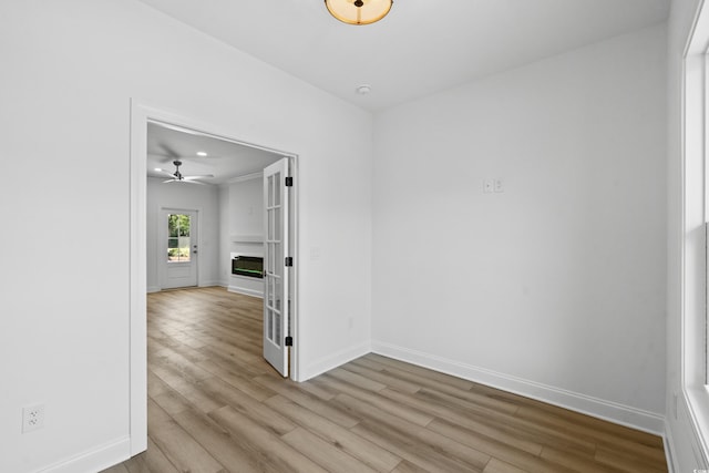 unfurnished room featuring ceiling fan and light wood-type flooring