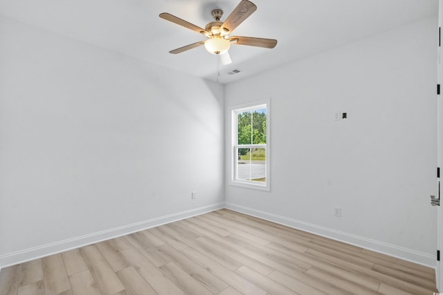 empty room with ceiling fan and light hardwood / wood-style floors