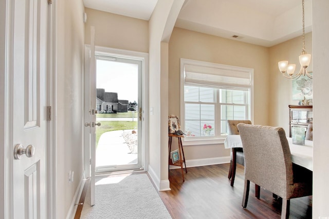 dining room featuring hardwood / wood-style flooring, a wealth of natural light, and a notable chandelier