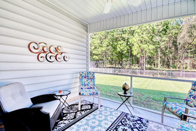 sunroom featuring plenty of natural light, wooden ceiling, and ceiling fan