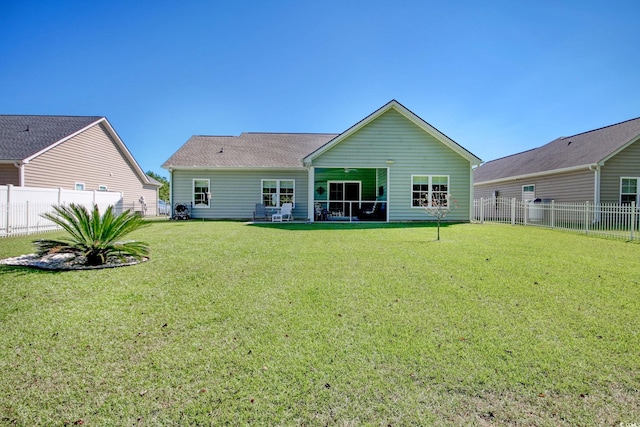 rear view of property with a lawn