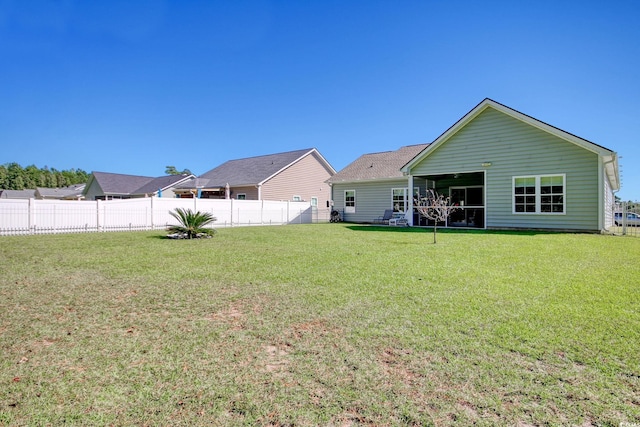 rear view of property with a yard