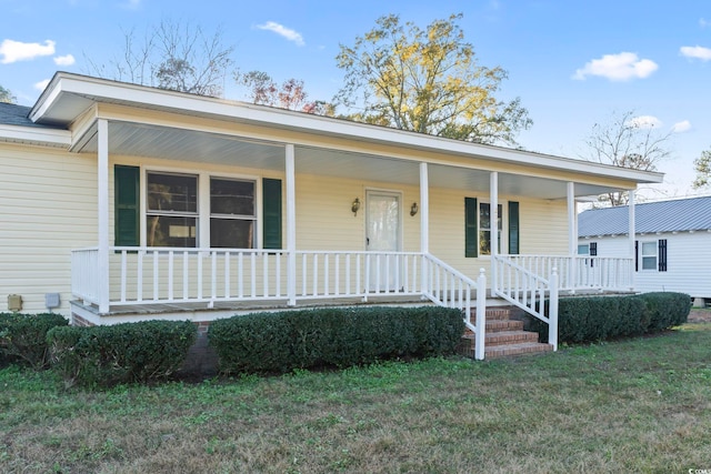 view of front of property with covered porch and a front yard