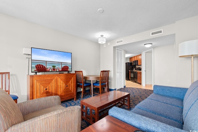 living room featuring light colored carpet and a textured ceiling