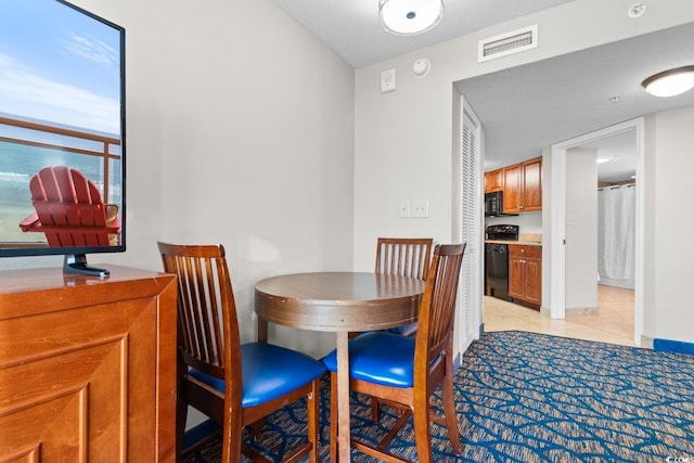 tiled dining room with a textured ceiling