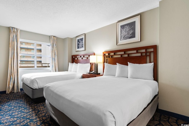 bedroom featuring carpet floors and a textured ceiling