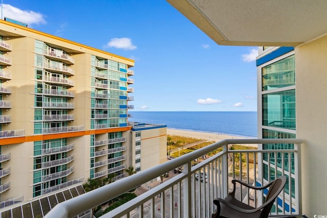 balcony with a beach view and a water view