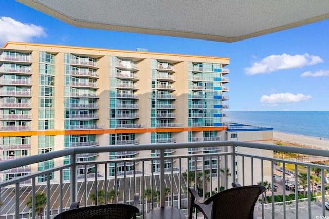 balcony with a water view and a beach view