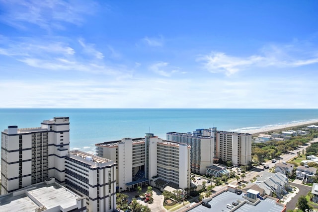 birds eye view of property featuring a water view and a beach view