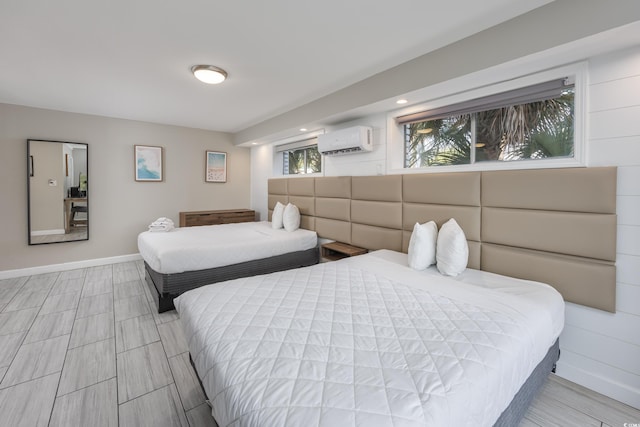 bedroom featuring an AC wall unit