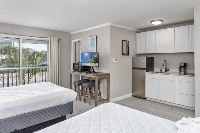 bedroom featuring sink, stainless steel fridge, and ornamental molding