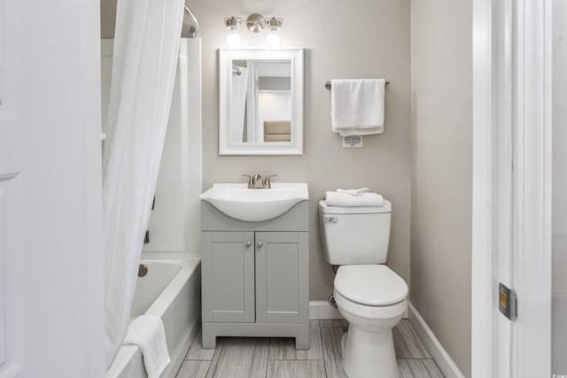 full bathroom featuring toilet, vanity, and shower / tub combo