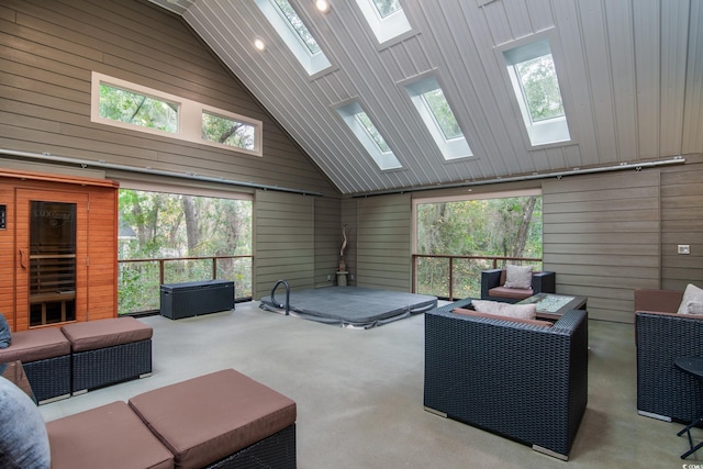 interior space featuring carpet flooring, wood walls, and high vaulted ceiling