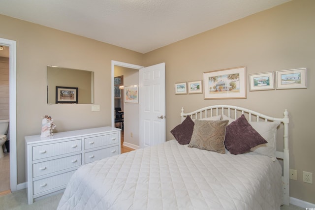 bedroom featuring a textured ceiling and light carpet