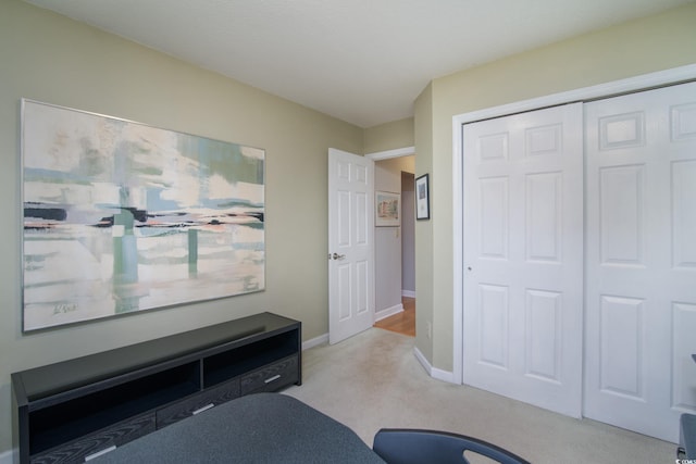 bedroom with a closet and light colored carpet