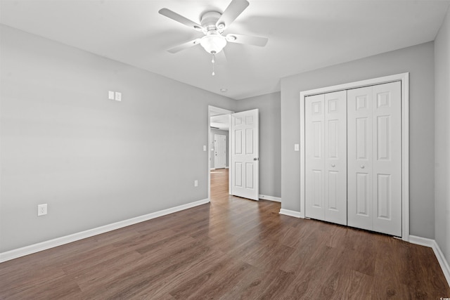 unfurnished bedroom with a closet, dark hardwood / wood-style floors, and ceiling fan