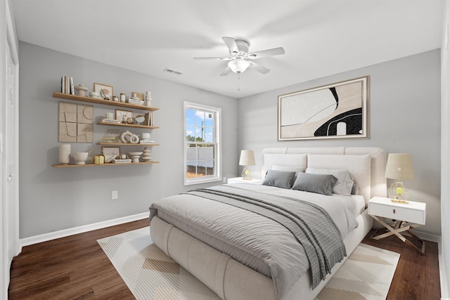 bedroom with dark hardwood / wood-style floors and ceiling fan