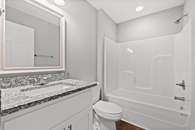 full bathroom featuring wood-type flooring, vanity, toilet, and shower / bathtub combination