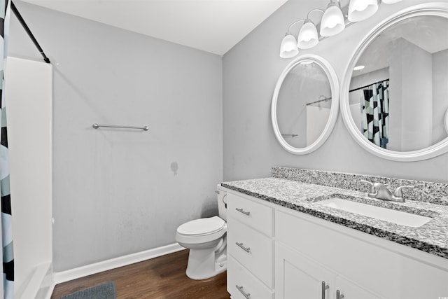 bathroom featuring curtained shower, toilet, vanity, and hardwood / wood-style flooring