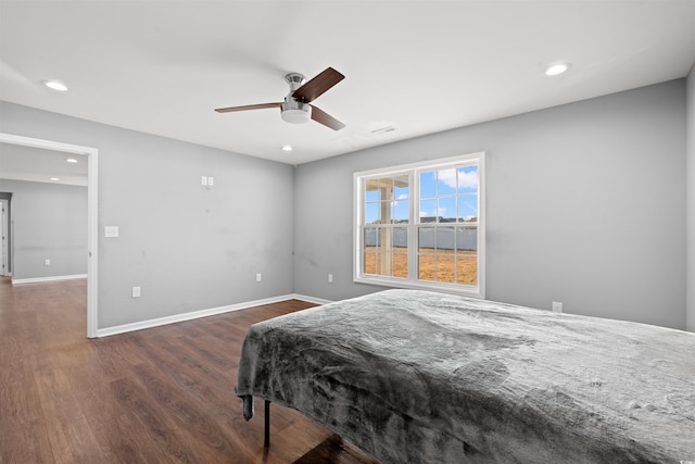 bedroom with ceiling fan and dark wood-type flooring