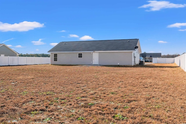 rear view of house featuring a yard