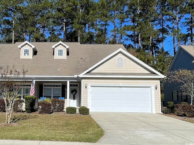 view of front of property featuring a front yard and a garage