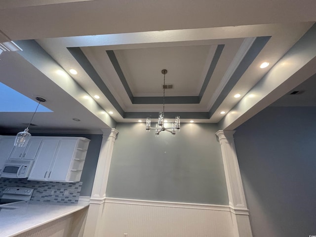 interior space featuring open shelves, decorative columns, wainscoting, light countertops, and white cabinetry