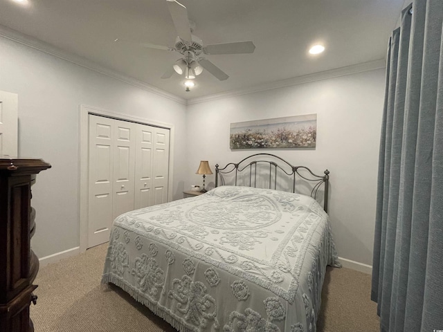 bedroom featuring crown molding, baseboards, carpet, and a closet