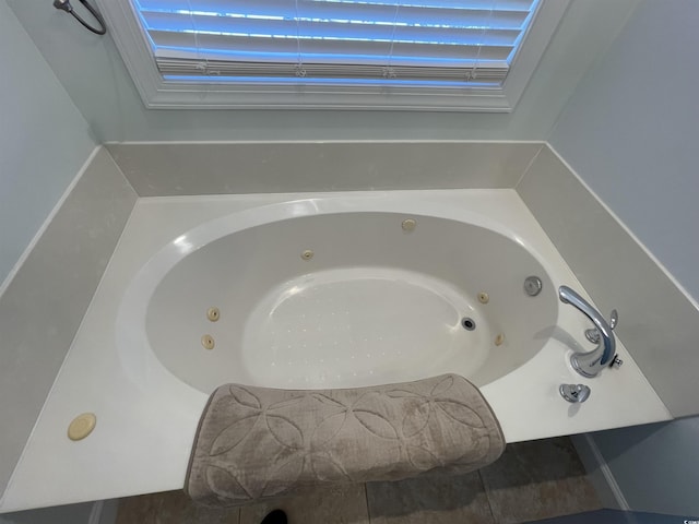 room details featuring a tub with jets