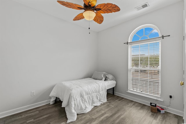 bedroom featuring ceiling fan, lofted ceiling, and hardwood / wood-style flooring