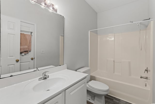 full bathroom featuring toilet, wood-type flooring, vanity, and  shower combination