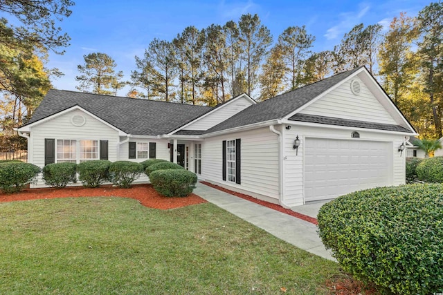 ranch-style home featuring a garage and a front lawn