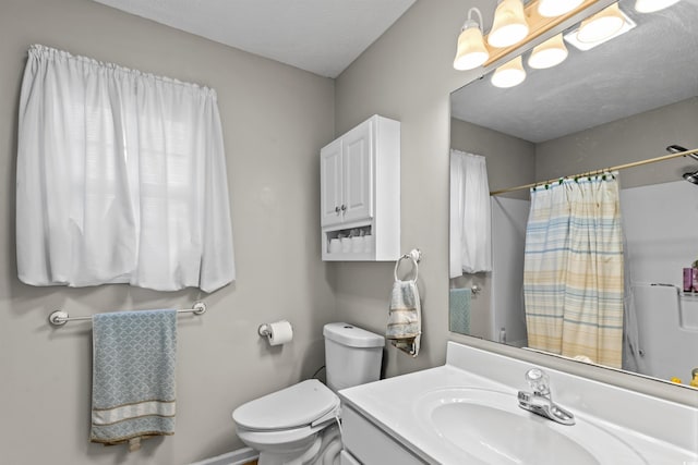 bathroom featuring a shower with curtain, vanity, a textured ceiling, and toilet