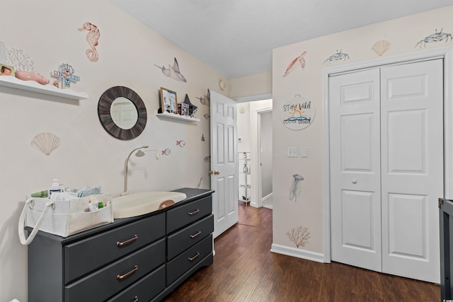 bedroom with dark hardwood / wood-style flooring, a closet, and sink