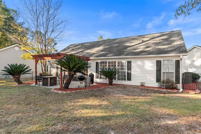 rear view of property with a pergola, a yard, and a patio area