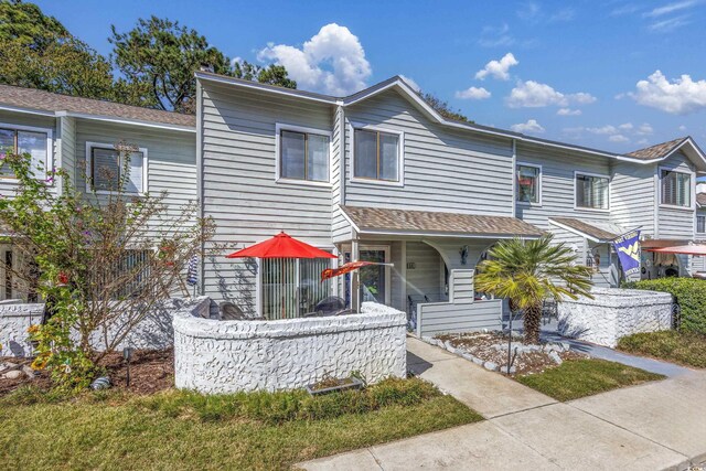 86 Shadow Moss Pl Unit 86, North Myrtle Beach, SC 29582 - townhome / multi-family property featuring a porch and a shingled roof