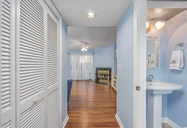 86 Shadow Moss Pl Unit 86, North Myrtle Beach, SC 29582 - corridor with a textured ceiling, wood finished floors, and a sink