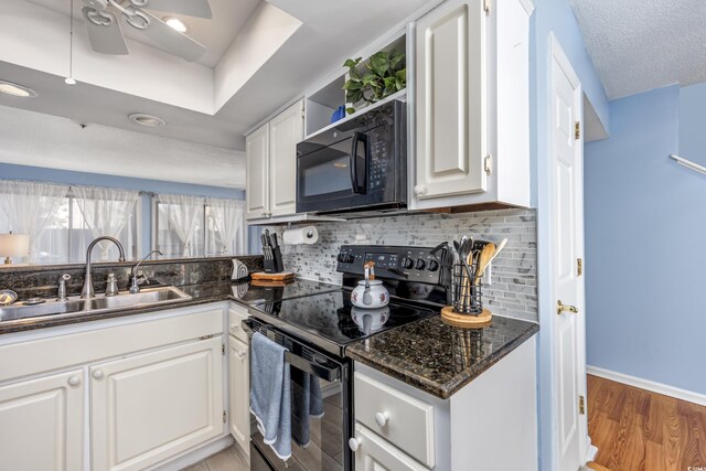 86 Shadow Moss Pl Unit 86, North Myrtle Beach, SC 29582 - kitchen with black appliances, a sink, tasteful backsplash, a ceiling fan, and white cabinetry
