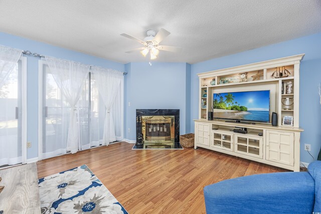 86 Shadow Moss Pl Unit 86, North Myrtle Beach, SC 29582 - living area featuring a premium fireplace, a ceiling fan, wood finished floors, and a textured ceiling