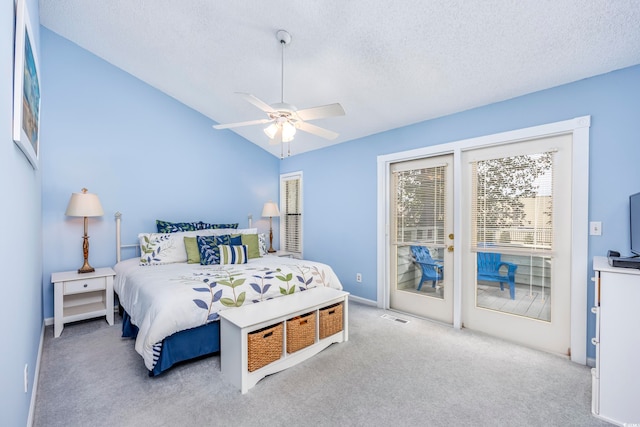 carpeted bedroom featuring access to outside, ceiling fan, a textured ceiling, and vaulted ceiling