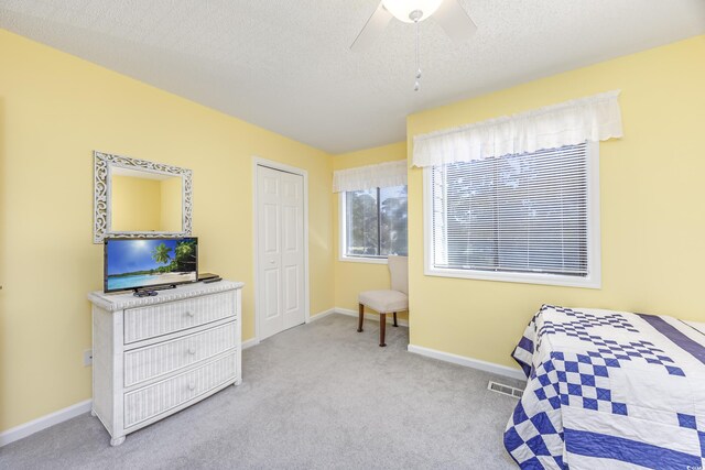 86 Shadow Moss Pl Unit 86, North Myrtle Beach, SC 29582 - carpeted bedroom with a textured ceiling, baseboards, a ceiling fan, and a closet