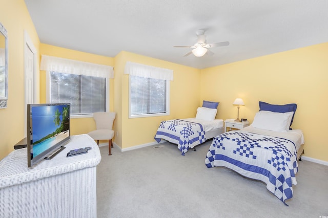 carpeted bedroom with multiple windows and ceiling fan