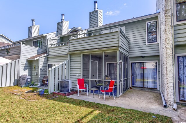 86 Shadow Moss Pl Unit 86, North Myrtle Beach, SC 29582 - back of property featuring a chimney, cooling unit, a patio area, a yard, and a sunroom