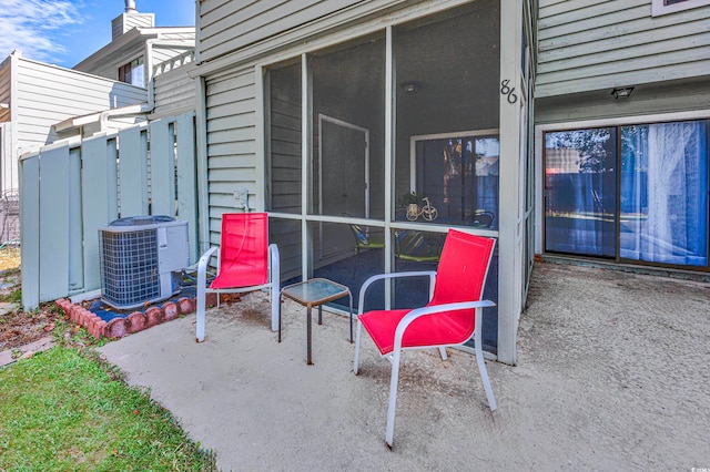 view of patio with a sunroom and central air condition unit