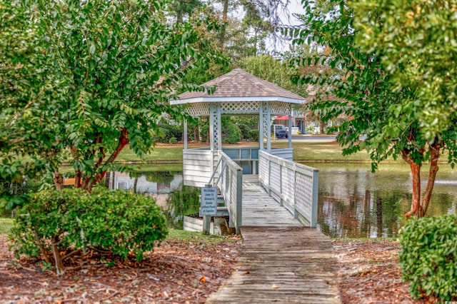 view of dock with a gazebo and a water view