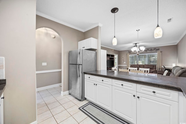 kitchen with stainless steel refrigerator, light tile patterned floors, pendant lighting, white cabinets, and ornamental molding