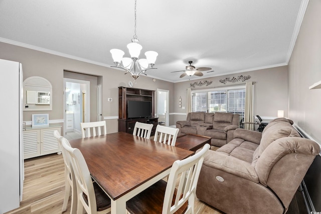 dining room featuring ceiling fan with notable chandelier, light wood-type flooring, and ornamental molding