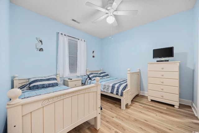 bedroom with ceiling fan and light hardwood / wood-style flooring